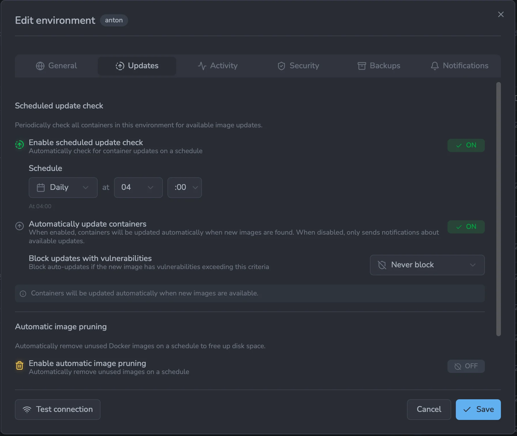 The Updates tab of the environment editor showing the Scheduled update check section: an 'Enable scheduled update check' toggle, a daily schedule at 04:00, an 'Automatically update containers' toggle, and a 'Block updates with vulnerabilities' selector set to 'Never block'.